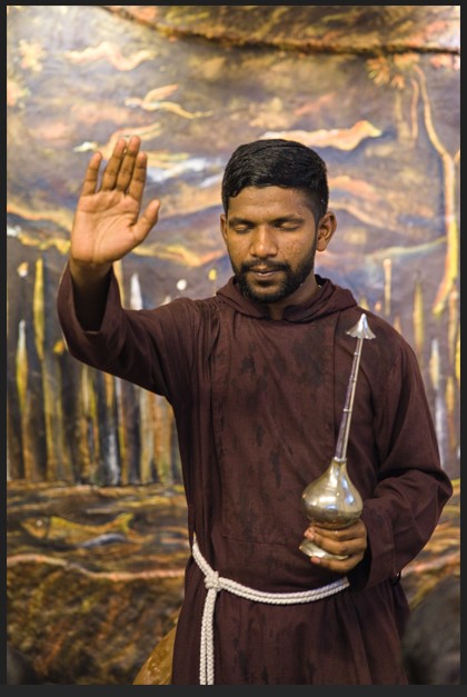 A priest blesses the devotees